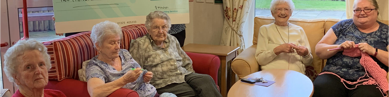 the knitting group receiving a cheque