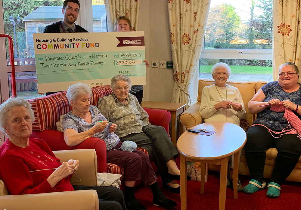 the knitting group receiving a cheque